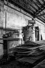 Interior Equipment and Pile of Tin in Black and White Interior of Old Building