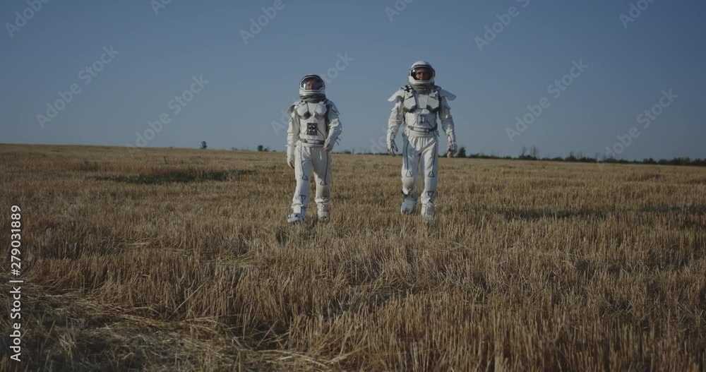 Canvas Prints two astronauts crossing a field