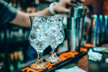 Two glasses with ice. Cocktail at the night club