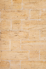 The building is made of natural sandstone. Brick wall.