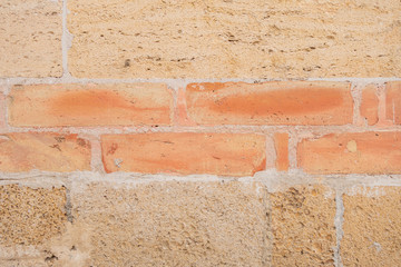The building is made of natural sandstone. Brick wall.