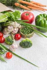 Healthy food in paper bag of different  vegetables on white background. Top view.
