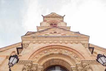 The building is made of natural sandstone. Facade of a catholic temple bottom view.