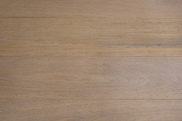 Parquet made of natural hardwood with a glare of sunlight.