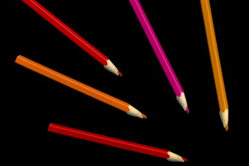 Old colored pencils lying on a black background - 279034289