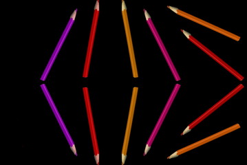 Old colored pencils lying on a black background - 279034412
