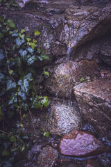 Water dripping over stones