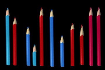 Old colored pencils lying on a black background - 279034479