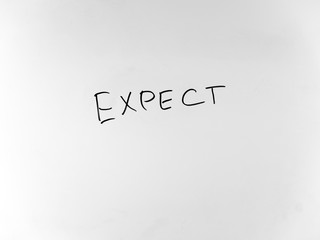 written in marker by hand text expect