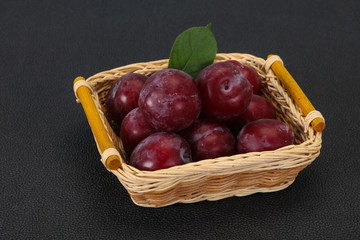 Plum heap in the wooden basket