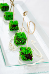 Top view catering banquet table with different food snacks and appetizers. Cold snacks, close up. Assorted canapes with caviar on a serving spoon iIsolated on white background.