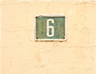 6, number six, house number plate on a wall.
