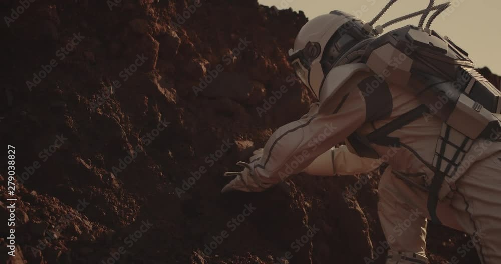 Canvas Prints astronaut examining rock on mars