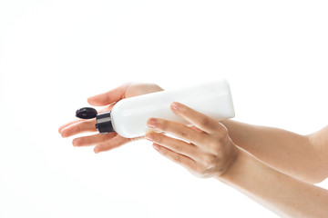 hand with bottle of perfume isolated on white