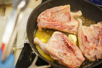 Process of cooking and roasting meat in a pan. 
