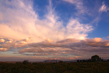 Sunset with clouds of evolution illuminated by the orange light of the sun