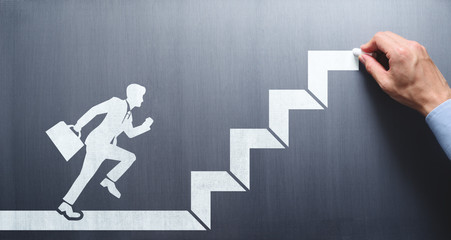 Step up of business career. Businessman drawing steps on chalkboard.