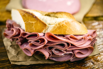 Traditional mortadella sandwich. Salt bread with bologna. Great snack of pork with bread, typical...