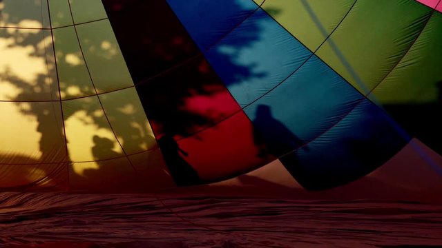 Colourful silhouettes of people playing close to hot air balloons. Creative backgrounds and rainbow colours with fire flares and shadows. Beautiful textures in summer light. Adventure and chill summer
