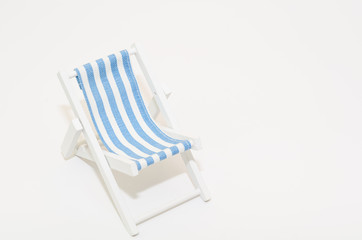 Beach chair with blue strips isolated on white background 