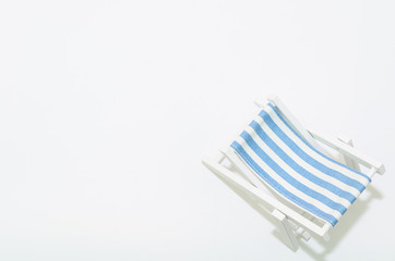 Beach chair with blue strips isolated on white background 