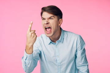 portrait of young man with finger on his lips