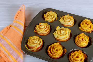 Baked potato roses with a bacon in oven pan