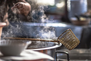Blurred wallpaper of smoke from boiling water,seasoning(noodles) with meat,cartilage It takes quite a long time to boil,has a fragrant flavor and is more delicious,seen in the street food district