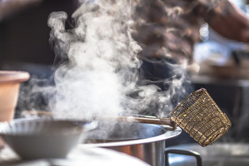 Blurred wallpaper of smoke from boiling water,seasoning(noodles) with meat,cartilage It takes quite a long time to boil,has a fragrant flavor and is more delicious,seen in the street food district