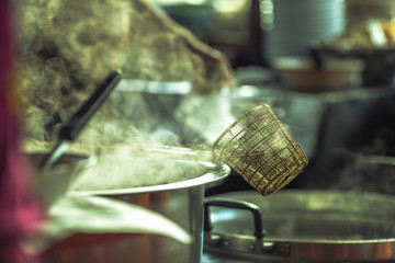 Blurred wallpaper of smoke from boiling water,seasoning(noodles) with meat,cartilage It takes quite a long time to boil,has a fragrant flavor and is more delicious,seen in the street food district