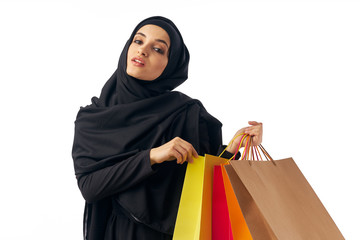 young woman with shopping bags isolated on white