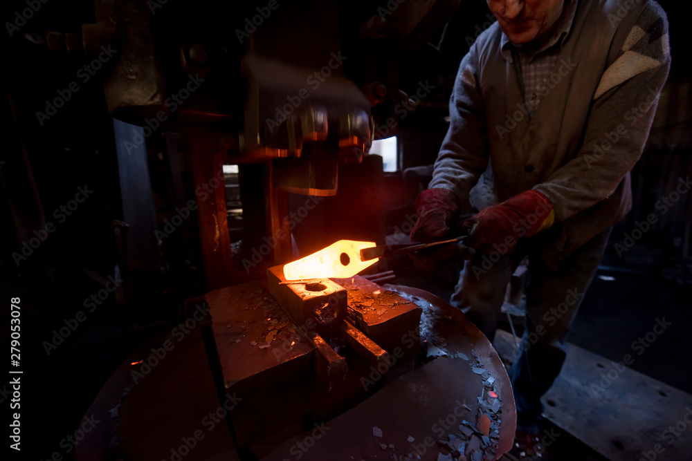 Wall mural blacksmith manually forging the molten metal