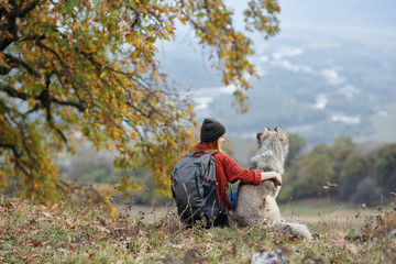 young couple with dog in autumn park