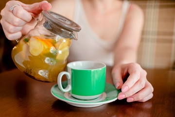 Female hands hold hot green  coffee cup beverage, drinks cappuccino. Horizontal several objects copyspace