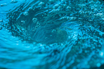 Blue ocean whirlpool spinning in counter clockwise motion