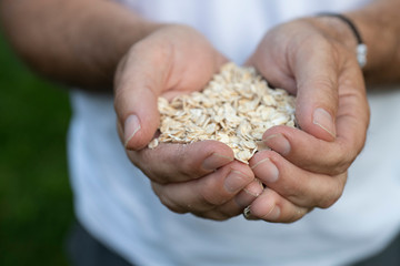 Man holding Oats in his hands