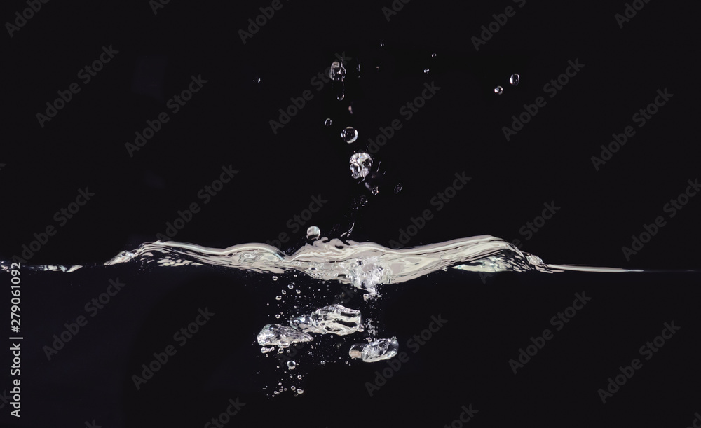 Poster droplet of water photographed while making splash on liquid surface, isolated on black background, c