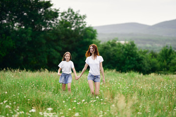 Fototapeta na wymiar happy mother and daughter in the field