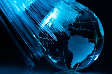 Glass Blue Globe against Fiber Optic Background