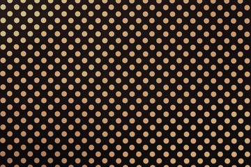 Black background from wrapping paper with a pattern of golden polka dot closeup.