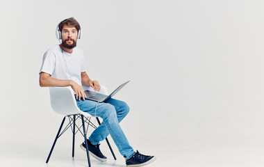 man sitting on chair and working on laptop