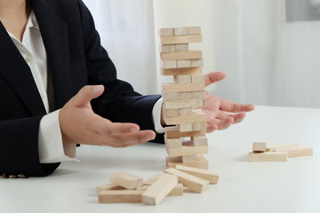 Planning risk and strategy in businessman gambling placing wooden block.Business concept for growth success process.