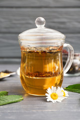 Cup of tasty chamomile tea on wooden table