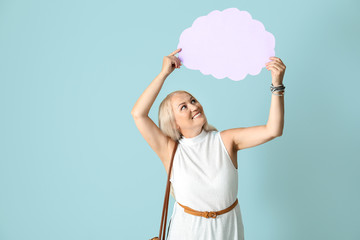 Mature woman with speech bubble on light background
