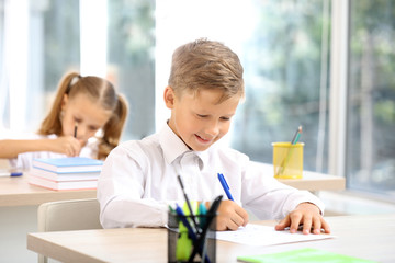 Pupil passing school test in classroom