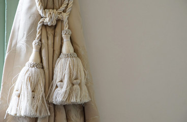 A wall and curtain tassel of the room - obrazy, fototapety, plakaty