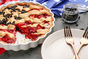 Tasty American flag pie and plate on grey background