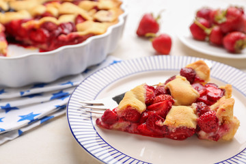 Plate with piece of tasty American flag pie on table