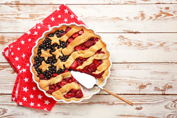 Tasty American flag pie on wooden background