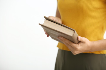 Woman with book on white background, closeup